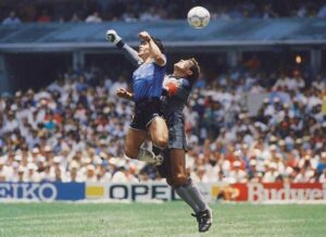 Famous football player maradona scoring goal with his hand